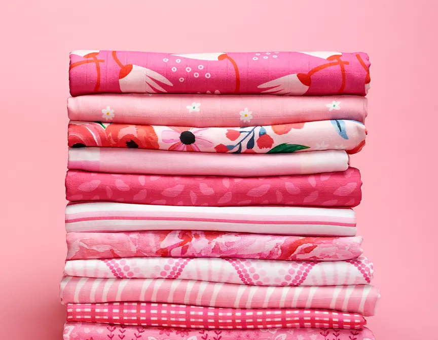 Pink fabrics in a stack.
