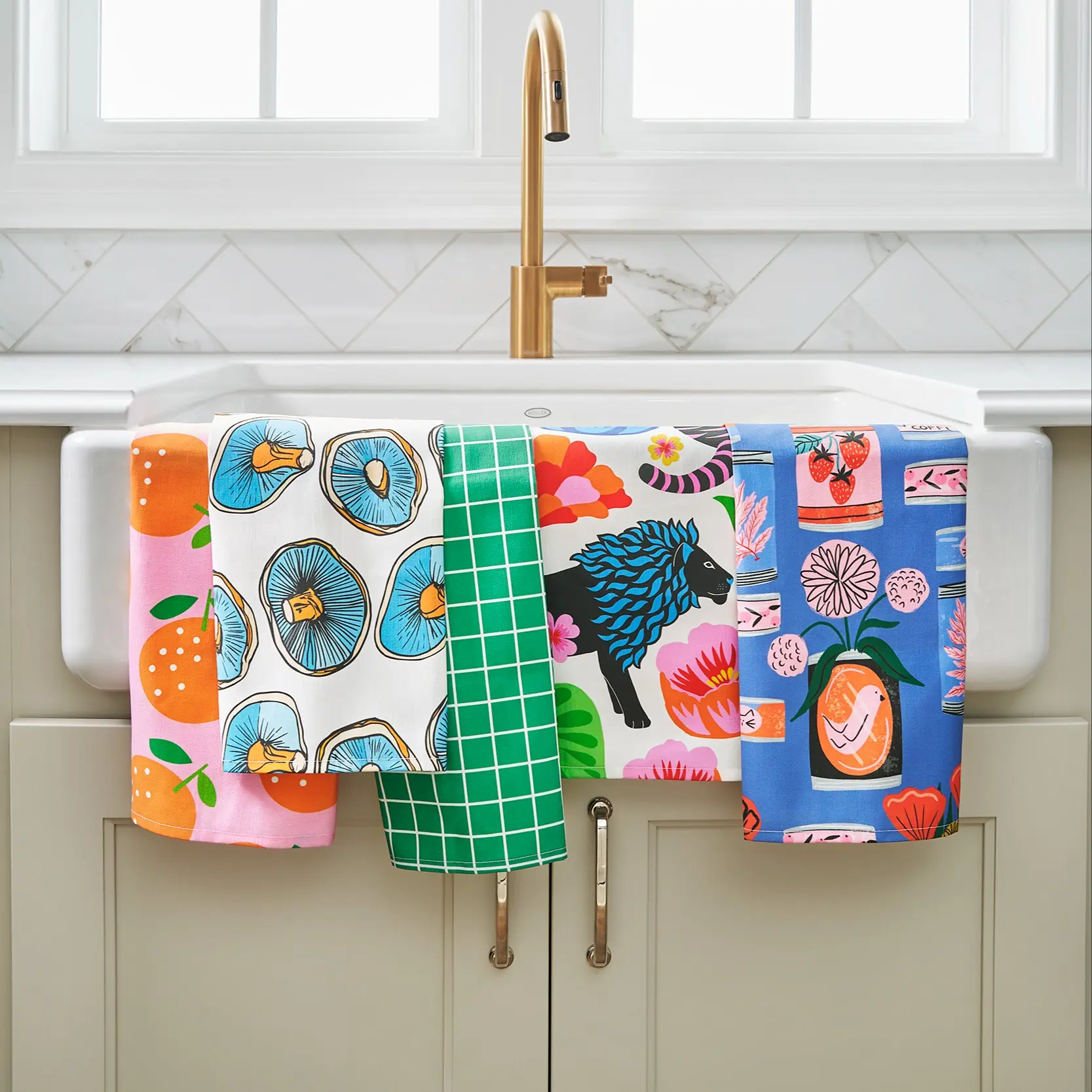 Colorful tea towels hanging from kitchen sink