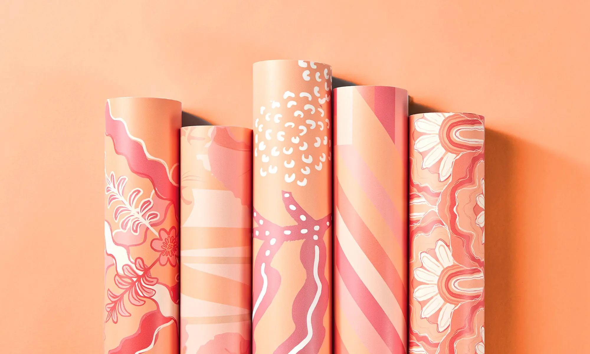 Five rolls of "Peach Fuzz" theme wallpaper with a peach background.