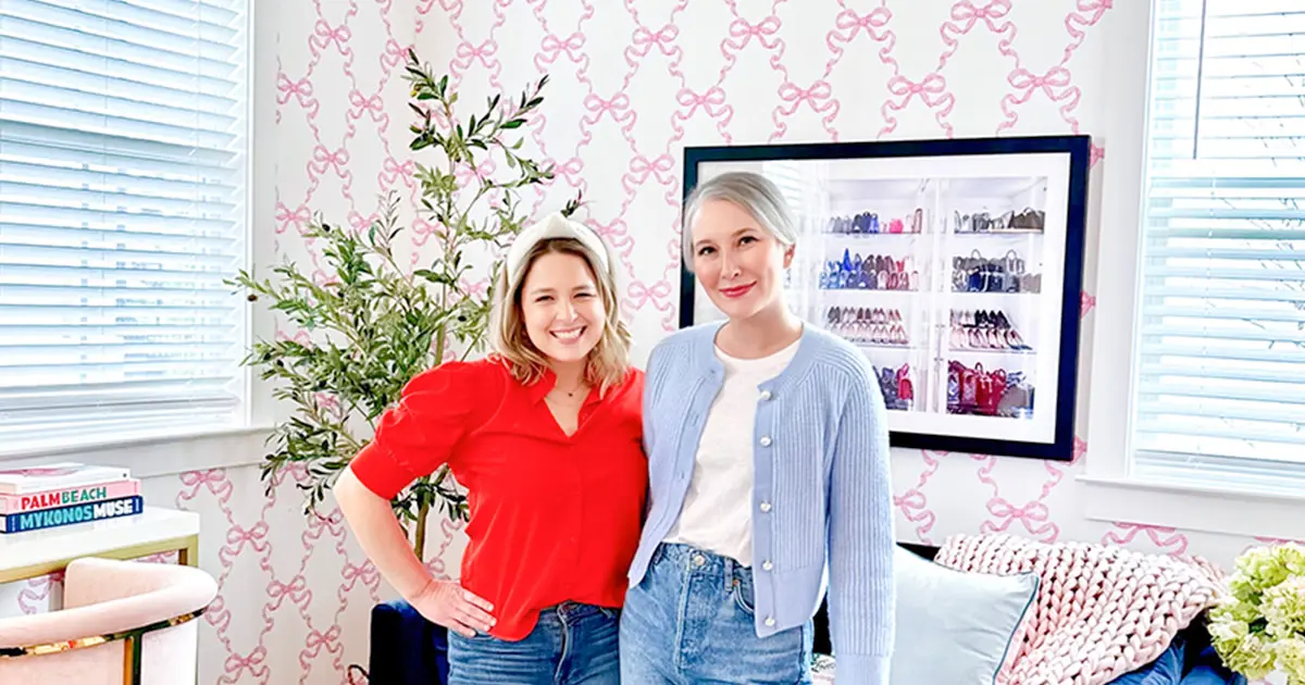 Headshot of Clea and Joanna in the room they designed with pink bow Spoonflower wallpaper.