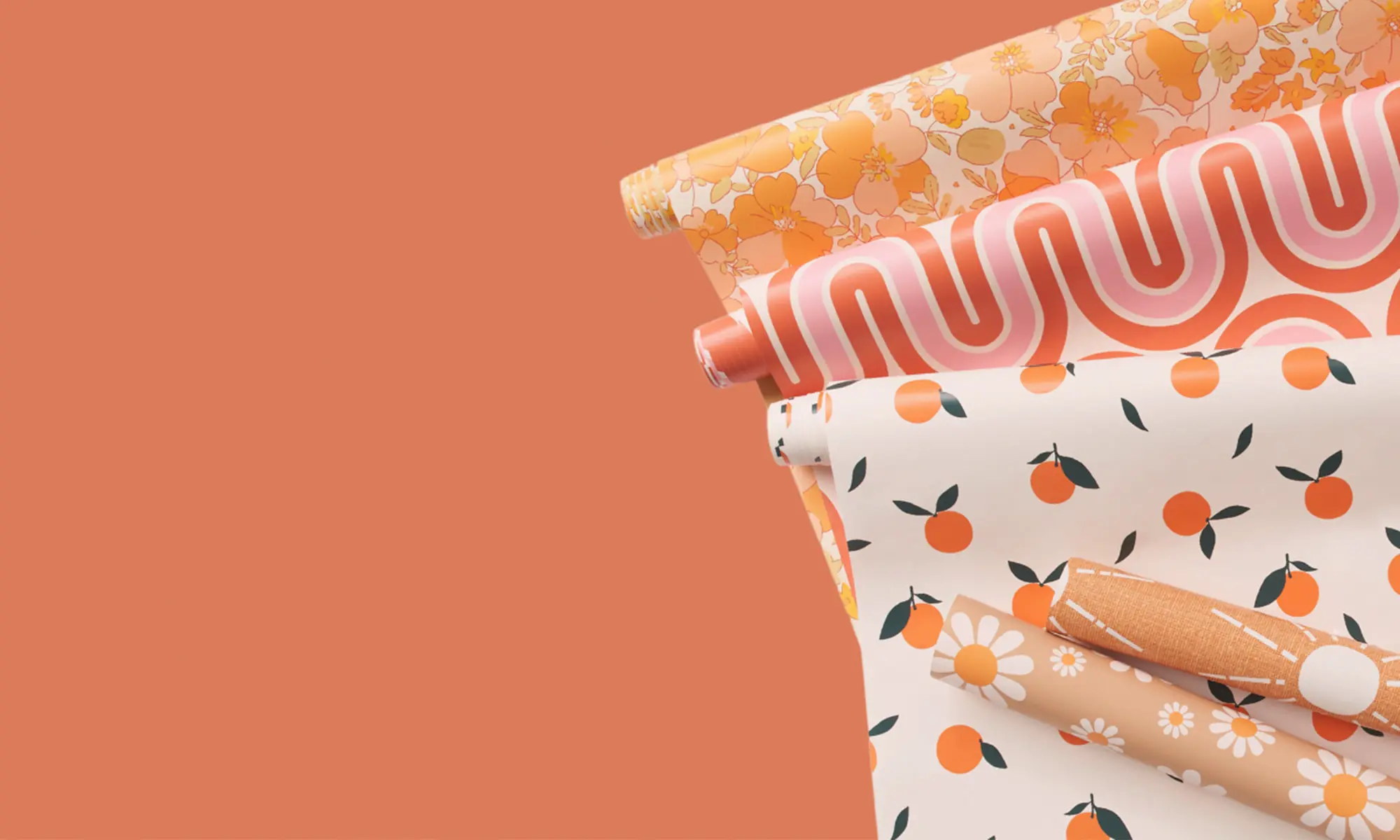 Peach colored rolls of wallpaper