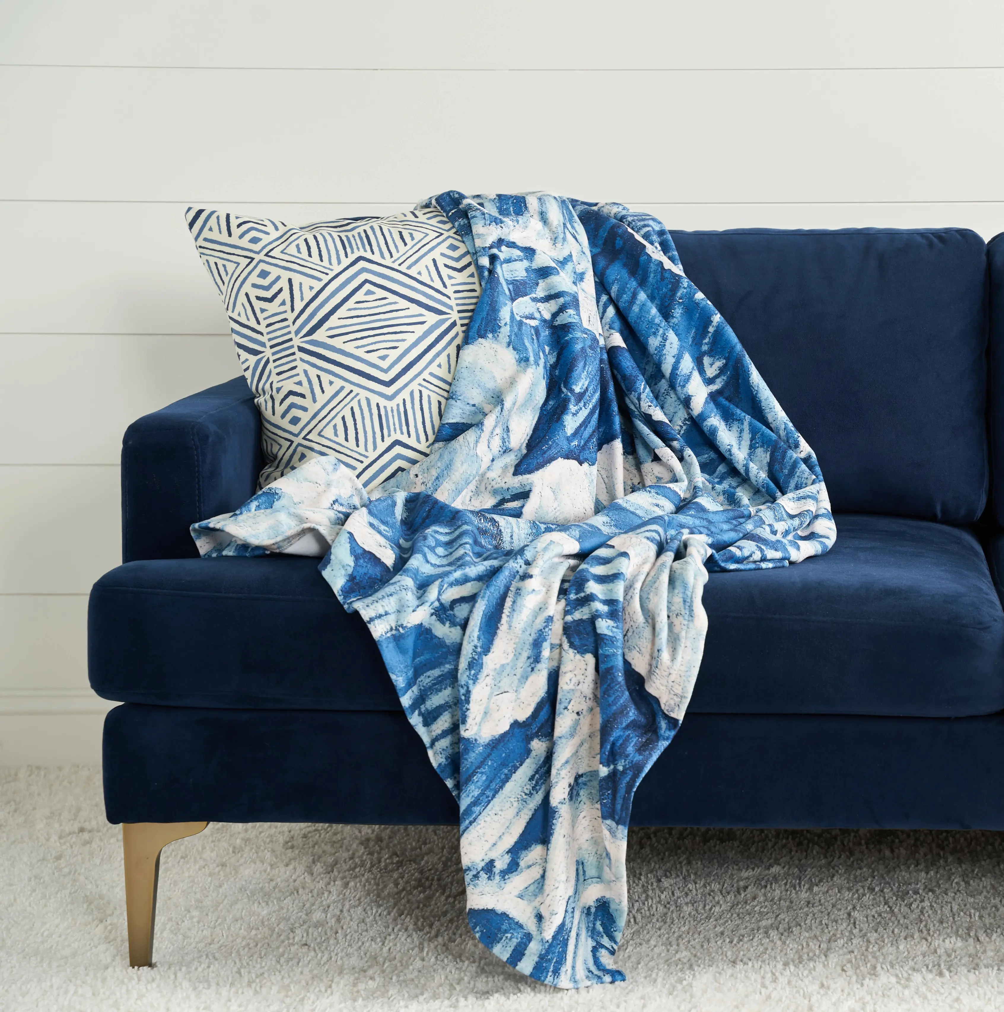 Blue throw blanket and pillow on couch