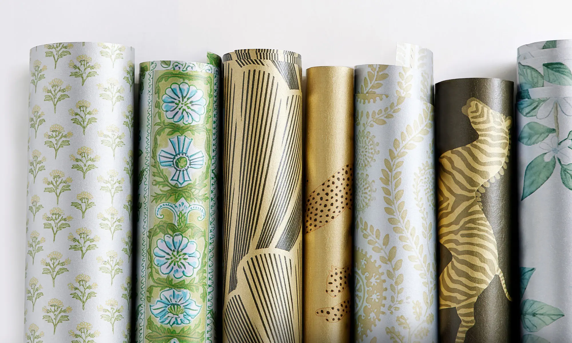 Rolls of metallic gold and silver wallpaper.